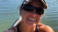Selfie of Sunshine Stewart paddleboarding on a Maine pond.