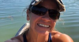 Selfie of Sunshine Stewart paddleboarding on a Maine pond.