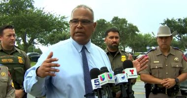 Screenshot of a press conference with law enforcement officials.