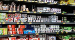 Walmart dairy aisle with various yogurts on shelves.
