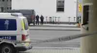 Police officers at a cordoned-off area.