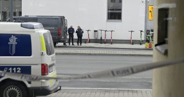 Police officers at a cordoned-off area.