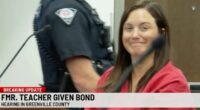 A former teacher smiles in court after being released on bail.