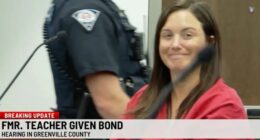A former teacher smiles in court after being released on bail.