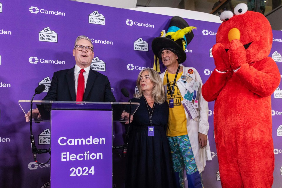 A hand placing a ballot paper into a ballot box.