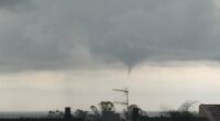 Waterspout over rooftops.