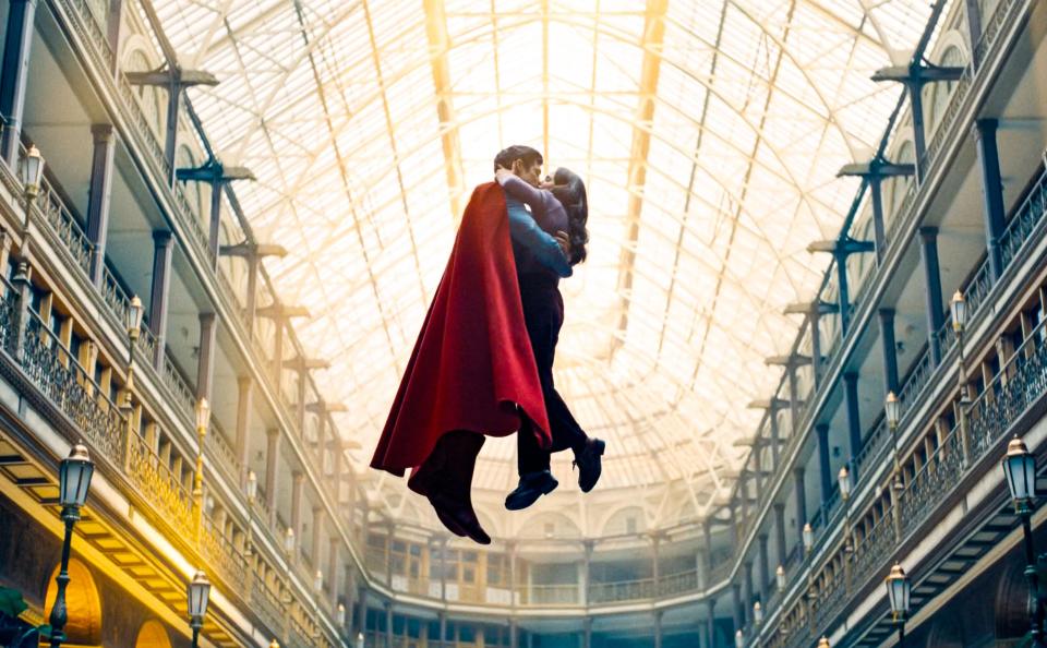 Superman and Lois Lane kissing while flying.