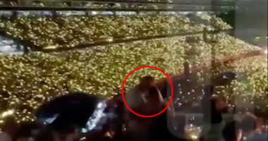 Stadium crowd holding up lights.