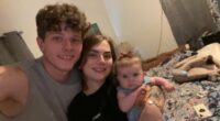 Photo of a young family: a father, mother, and baby.