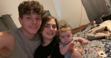Photo of a young family: a father, mother, and baby.
