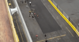 People walking on a dock.