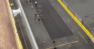 People walking on a dock.