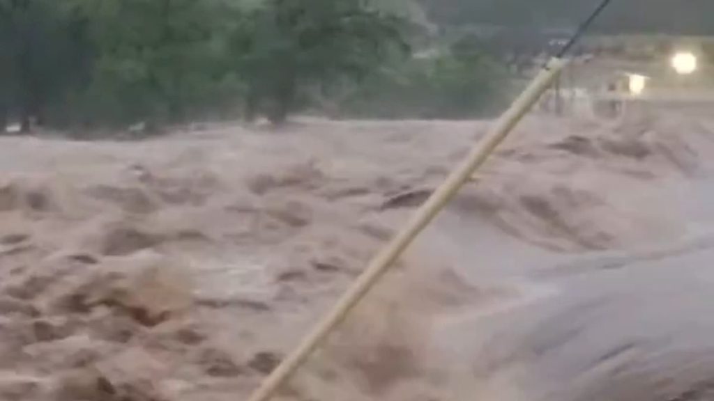Texan city begins to disappear underwater as flooded river bursts