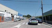Street scene of parked cars near a police vehicle.