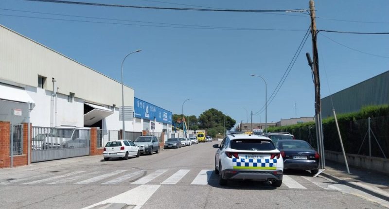 Street scene of parked cars near a police vehicle.