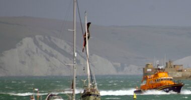 Lifeboat responding to a kite surfer incident near a yacht.
