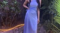 Woman in a light blue pleated dress.