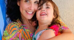 Photo of a mother hugging her young daughter.