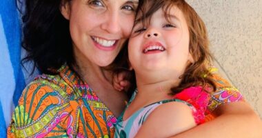 Photo of a mother hugging her young daughter.