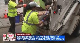 Screenshot of sanitation workers loading trash into a garbage truck during a strike.