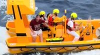 A rescue boat with several people aboard.