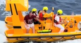 A rescue boat with several people aboard.