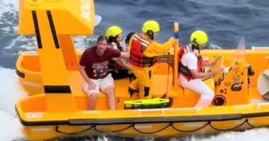 A rescue boat with several people aboard.