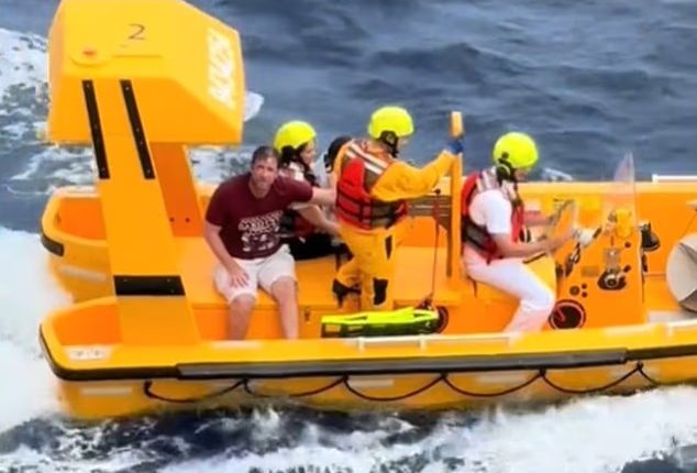 A rescue boat with several people aboard.