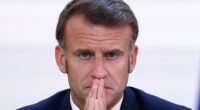 President Emmanuel Macron with hands clasped.