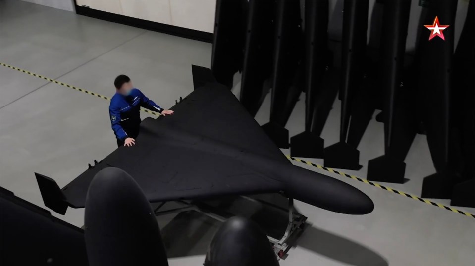 A person inspecting a Geran-2 drone in a factory.