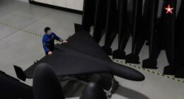 A person inspecting a Geran-2 drone in a factory.
