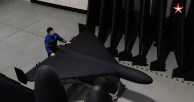A person inspecting a Geran-2 drone in a factory.