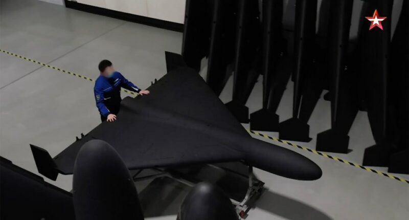 A person inspecting a Geran-2 drone in a factory.