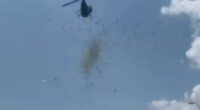 Helicopter dropping cash from the sky.