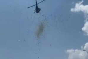 Helicopter dropping cash from the sky.