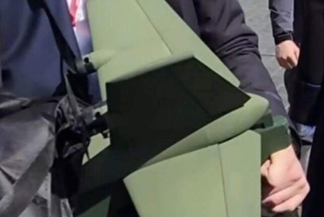 A security operative holding a drone interceptor.