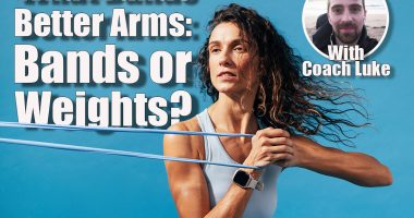 Close up of caucasian woman exercising with a resistance band. Young fitness female training on blue background.