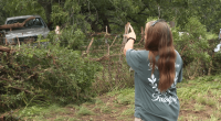 Leander woman shows the tree she climbed to survive floods during the early morning hours of July 5, 202