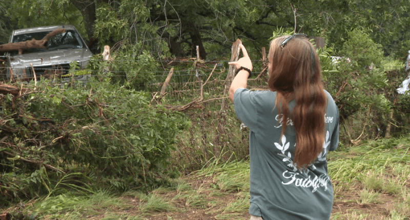 Leander woman shows the tree she climbed to survive floods during the early morning hours of July 5, 202