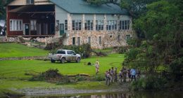 Officials search on the grounds of Camp Mystic on Sunday in Hunt, Texas.