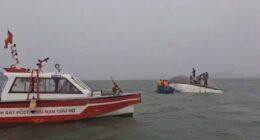 A search party searches Ha Long Bay after a tourist boat capsized.