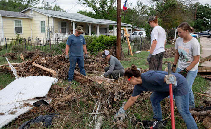 Armies of Texas volunteers dig out, clean up, after fatal floods