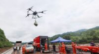 BEIJING, CHINA - JULY 28: Rescuers use a drone to transport relief supplies after intense downpour triggers road disruptions at Liulimiao Town in Huairou District on July 28, 2025 in Beijing, China. Since July 26, consecutive rainfall has affected Beijing's northern suburban districts of Miyun, Huairou and Yanqing. The intense downpour triggered flooding and landslides, impacting several villages and disrupting roads, power supplies and communications in some areas. (Photo by Jia Tianyong/China