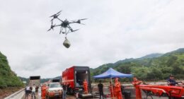 BEIJING, CHINA - JULY 28: Rescuers use a drone to transport relief supplies after intense downpour triggers road disruptions at Liulimiao Town in Huairou District on July 28, 2025 in Beijing, China. Since July 26, consecutive rainfall has affected Beijing's northern suburban districts of Miyun, Huairou and Yanqing. The intense downpour triggered flooding and landslides, impacting several villages and disrupting roads, power supplies and communications in some areas. (Photo by Jia Tianyong/China
