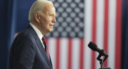 Biden speaks at a podium in front of a US flag