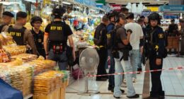 Police monitoring the cordoned area in Or Tor Kor market on July 28, 2025 in Bangkok, Thailand, after an active shooter situation