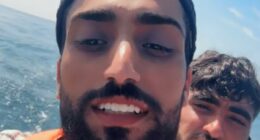 Grinning small boat migrant chronicles his journey across the Channel to the UK - as he films himself celebrating on Blackpool beach after illegally crossing into Britain