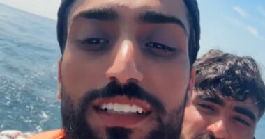 Grinning small boat migrant chronicles his journey across the Channel to the UK - as he films himself celebrating on Blackpool beach after illegally crossing into Britain