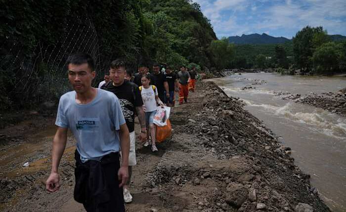 Heavy rain causes flooding, evacuations and at least 38 deaths around Beijing region