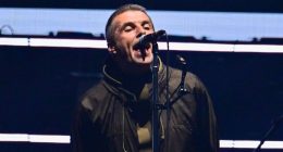 Oasis are back! First look as Liam and Noel Gallagher FINALLY arrive on stage at Cardiff's Principality Stadium and put on very united display as they stand hand-in-hand on first night of reunion tour - 15 years since split